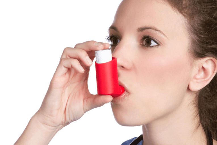 Pulmonary drug delivery girl with an inhalator in the mouth