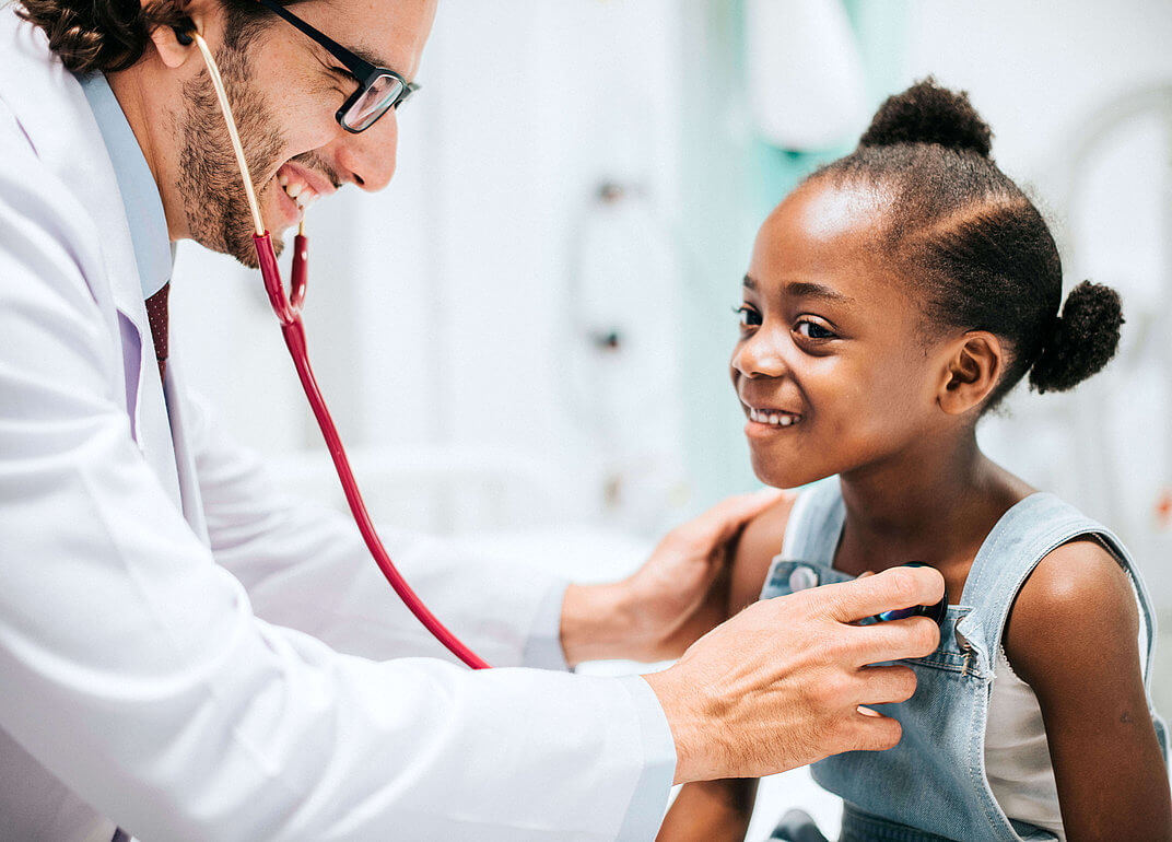 Pharma division about us doctor with stethoscope listening to child's heart